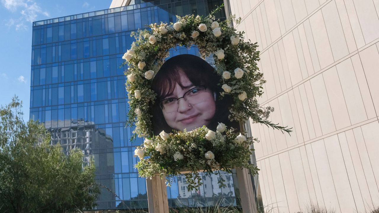 A wreath with a picture of Valentina Orellana-Peralta, is displayed at a news conference outside Los Angeles Police Department Headquaters in Los Angeles, Tuesday, Dec. 28, 2021. (AP Photo/Ringo H.W. Chiu)