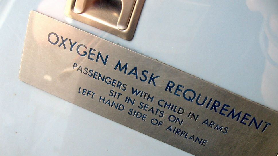 FILE- Sign regarding oxygen masks on plane. Image/Marcin Wichary, Flickr