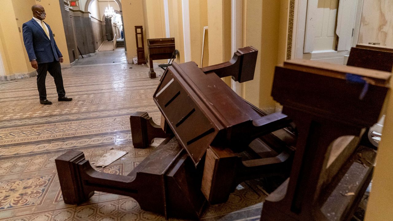 Sen. Tim Scott (R-S.C.) pauses to look at damage in the U.S. Capitol early Thursday, January 7, 2021, a day after violent protesters stormed the Capitol Building in Washington. (Andrew Harnik/AP)