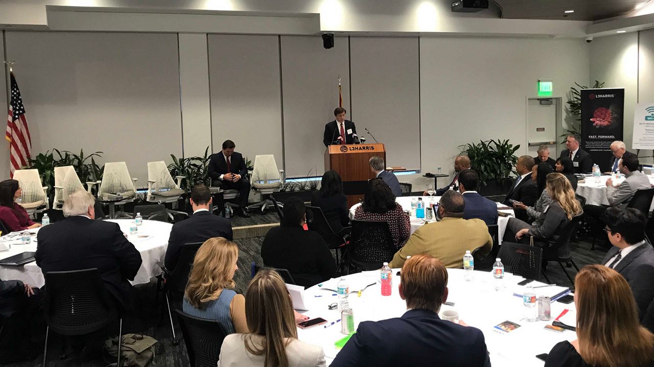 Gov. Ron DeSantis (seated in the front) spoke to dignitaries and community leaders at L3Harris corporate headquarters on Tuesday, January 7, 2020, about the expansion of aerospace companies. (Greg Pallone/Spectrum News 13)
