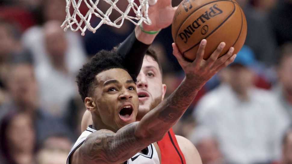San Antonio Spurs guard Dejounte Murray, front, shoots over Portland Trail Blazers center Jusuf Nurkic during the second half of an NBA game in Portland on Jan. 7, 2018. (AP/Craig Mitchelldyer)