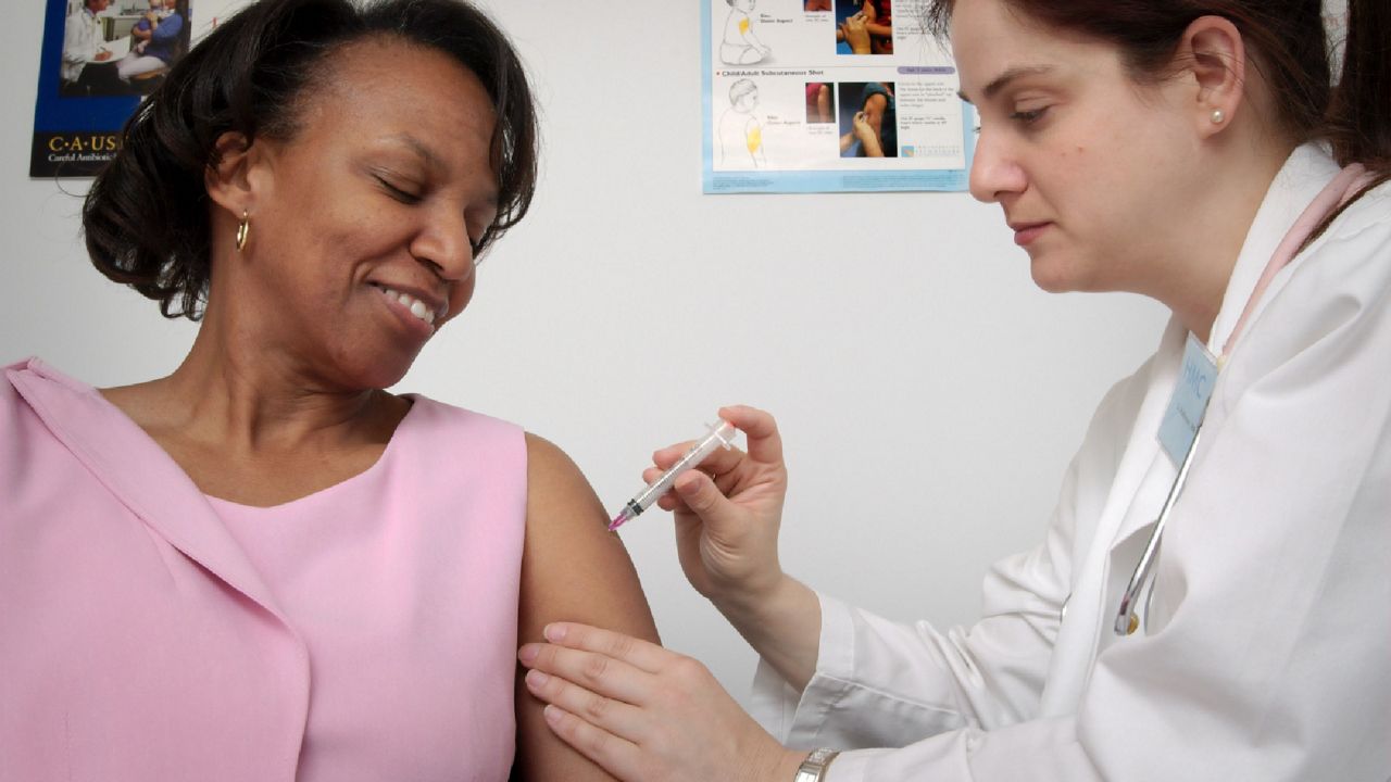 Woman gets flu shot. (CDC)