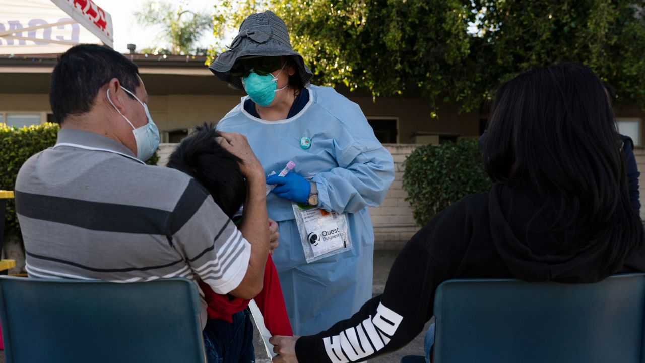 Nurse practitioner Rita Ray collects a nasal swab sample from Sebastian Hernandez, 5, for a COVID-19 test at Families Together of Orange County community health center in Tustin, Calif., Jan. 6, 2022. (AP Photo/Jae C. Hong, File)