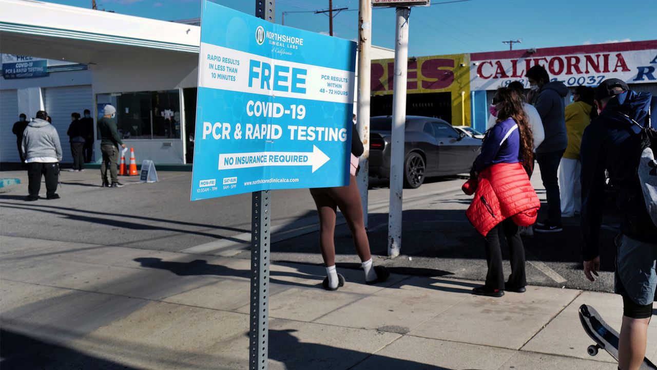 People line up at a gas station for a free COVID-19 rapid test as California braces for a post-holiday virus surge in the Reseda section of Los Angeles on Dec. 26, 2021. (AP Photo/Richard Vogel)