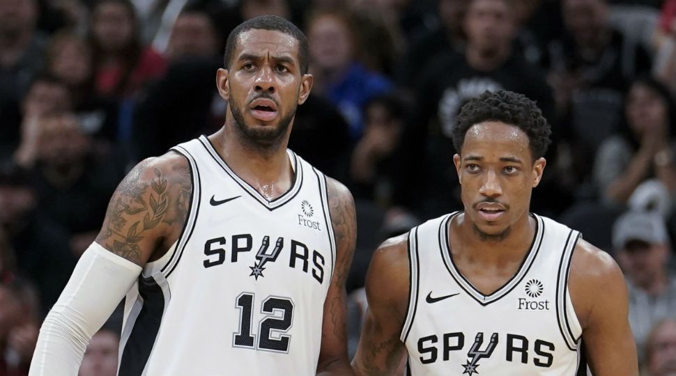 San Antonio Spurs' LaMarcus Aldridge (12) stands next to DeMar DeRozan during the second half of the team's NBA basketball game against the Oklahoma City Thunder January 10 in San Antonio. (AP Image)