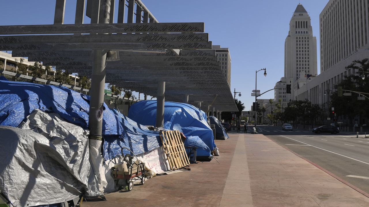 A homeless encampment is seen atop the Main St. overpass of the 101 freeway during the coronavirus outbreak, Thursday, May 21, 2020, in downtown Los Angeles. (AP Photo/Mark J. Terrill)