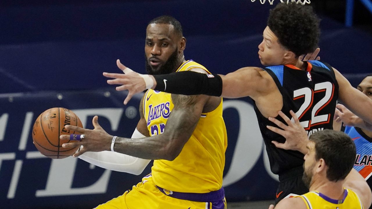 Los Angeles Lakers forward LeBron James, left, moves around Oklahoma City Thunder forward Isaiah Roby (22) during the first half of an NBA basketball game Wednesday, Jan. 13, 2021, in Oklahoma City. (AP Photo/Sue Ogrocki)