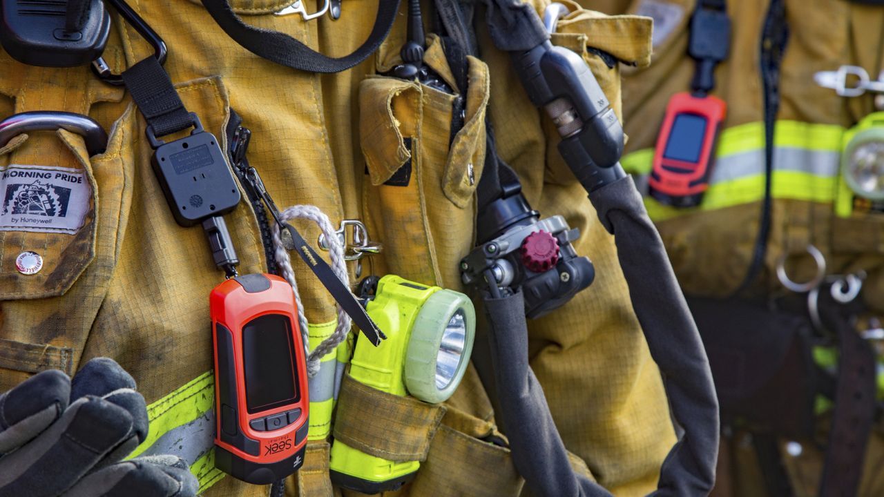 Los Angeles Fire Department firefighter are equipped with hand-held thermal imaging cameras (TIC), orange devices, at the Fire Station 1 in the Lincoln Heights neighborhood of Los Angeles Friday, March 22, 2019. (Los Angeles Fire Department via AP)