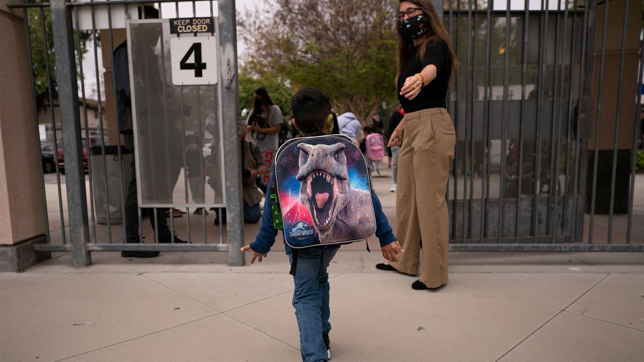 Kindergartener Angel Hernandez leaves after the first day of in-person learning at Maurice Sendak Elementary School in Los Angeles, Tuesday, April 13, 2021. (AP Photo/Jae C. Hong)