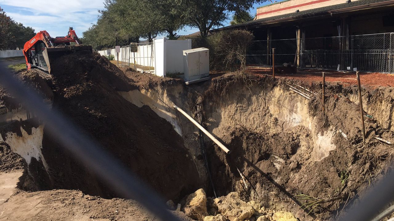 In addition to reopening, the county said Thursday the sinkhole grew an additional four feet on one side and is now 50 ft. wide. This is wholly on private property, and the owner’s contractor is working on additional efforts to fix the hole. (Sarah Blazonis/Spectrum Bay News 9)