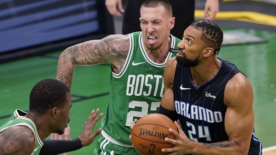 Orlando Magic center Khem Birch (24) looks to shoot against Boston Celtics center Daniel Theis (27) and guard Javonte Green, left, during the first half of an NBA basketball game Friday, Jan. 15, 2021, in Boston. (AP Photo/Elise Amendola)