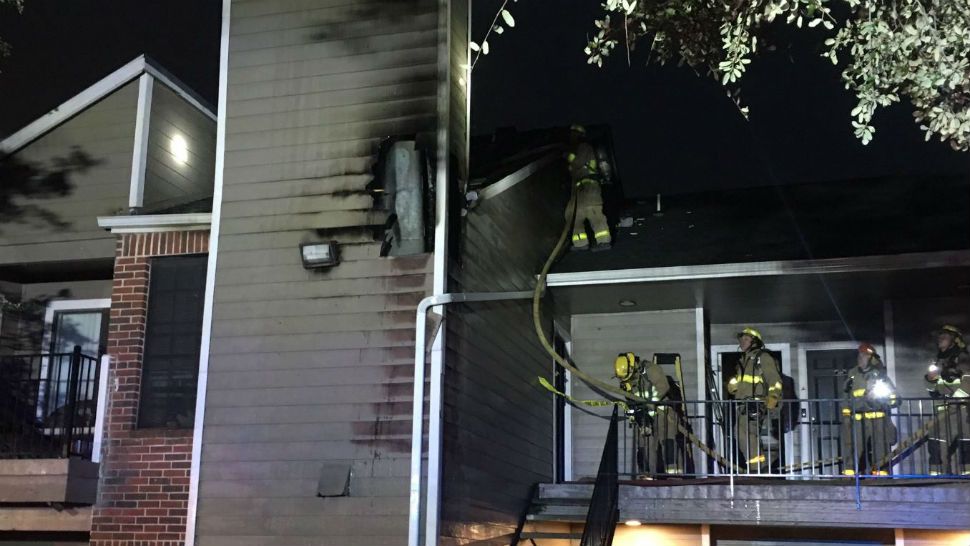 Austin firefighters work to put out a fire at the High Oaks Apartments. (Courtesy: Twitter via @AustinFireInfo)