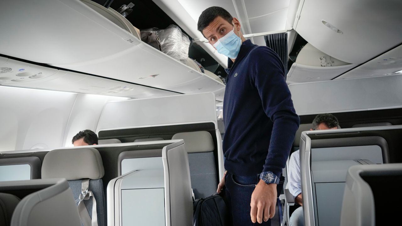 Novak Djokovic prepares to take his seat on a plane to Belgrade, in Dubai, United Arab Emirates, Monday, Jan. 17, 2022. (AP Photo/Darko Bandic)