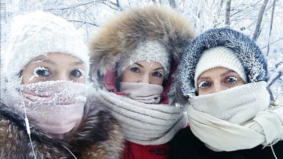 In this photo taken on Sunday, Jan. 14, 2018, Anastasia Gruzdeva, left, poses for selfie with her friends as the temperature dropped to about -50 degrees (-58 degrees Fahrenheit) in Yakutsk, Russia.  (sakhalife.ru photo via AP)