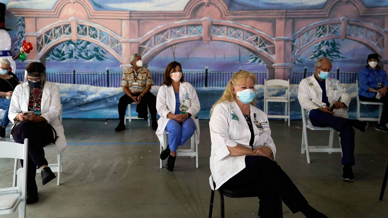 In this Jan. 7, 2021, file photo, medical workers wait in the holding area after getting the Pfizer-BioNTech COVID-19 vaccine at St. Joseph Hospital in Orange, Calif. (AP Photo/Jae C. Hong)
