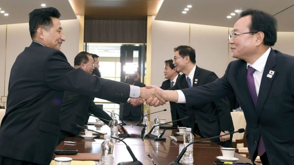 In this photo provided by South Korea Unification Ministry, South Korean Vice Unification Minister Chun Hae-sung, center right, shakes hands with the head of North Korean delegation Jon Jong Su during their meeting at Panmunjom in the Demilitarized Zone in Paju, South Korea, Wednesday, Jan. 17, 2018. The two Koreas are meeting Wednesday for the third time in about 10 days to continue their discussions on Olympics cooperation, days ahead of talks with the IOC on North Korean participation in the upcoming Winter Games in the South. (South Korea Unification Ministry via AP)