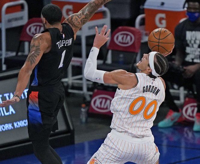 New York Knicks forward Obi Toppin (1) defends Orlando Magic forward Aaron Gordon (00) during the first half of an NBA basketball game, Monday, Jan. 18, 2021, in New York. (AP Photo/Kathy Willens, Pool)