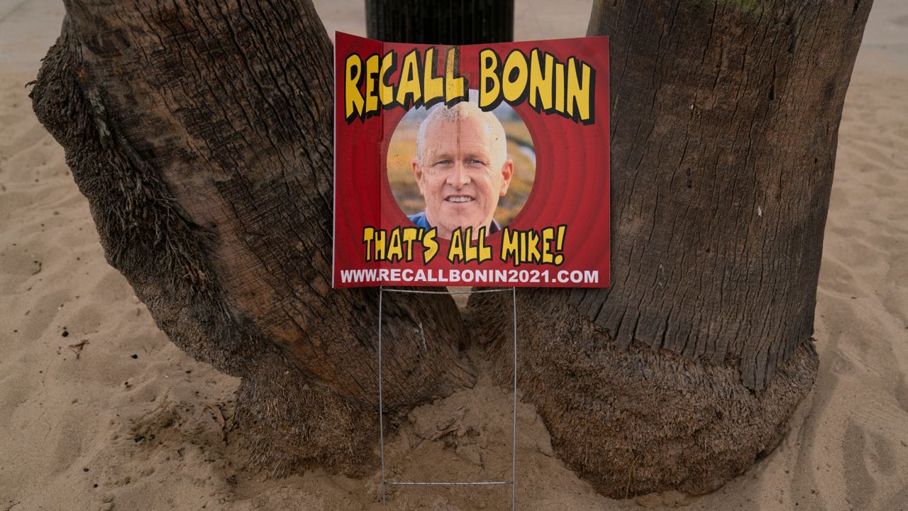 A sign opposing Los Angeles Councilman Mike Bonin, whose district includes Venice, is placed near a homeless encampment set up along the boardwalk in the Venice neighborhood of Los Angeles, Tuesday, June 29, 2021. (AP Photo/Jae C. Hong)