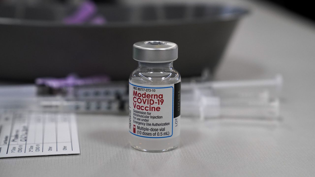 A vile of Moderna COVID-19 vaccine is seen at an ambulance company in Santa Fe Springs, Calif., Saturday, Jan. 9, 2021. (AP Photo/Jae C. Hong)