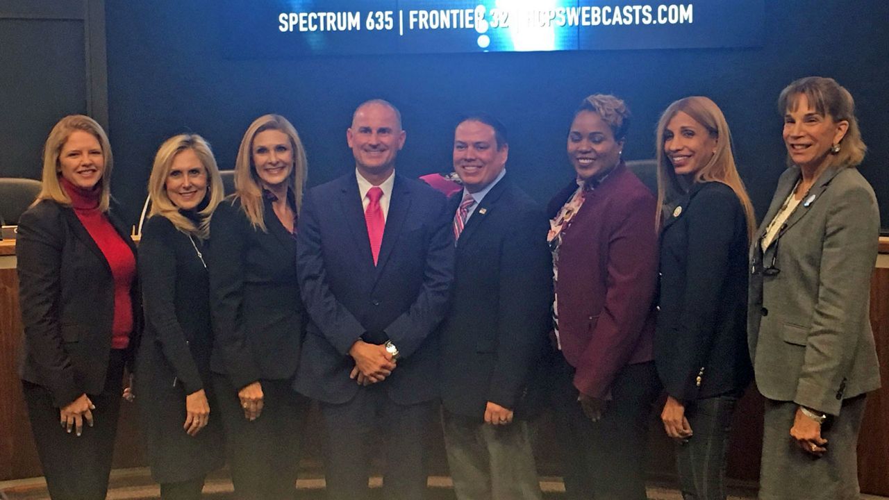 Addison Davis (center), who will assume the duties of Hillsborough County Schools Superintendent in June, poses for a photo with members of the school board. (Dave Jordan/Spectrum Bay News 9)