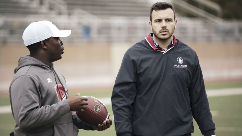 In this Jan. 22, 2019, photo released by the Alliance of American Football, Charlie Ebersol, CEO and co-founder of the Alliance of American Football, right, walks on the field next to Darwin Beacham, San Antonio Commanders equipment manager, in San Antonio. (Alliance of American Football via AP)