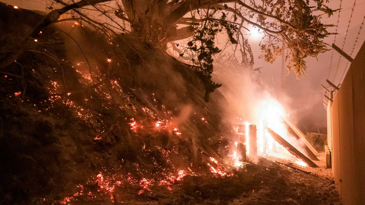 The Colorado Fire burns a fence off Highway 1 near Big Sur, Calif., on Saturday. (AP Photo/Nic Coury)