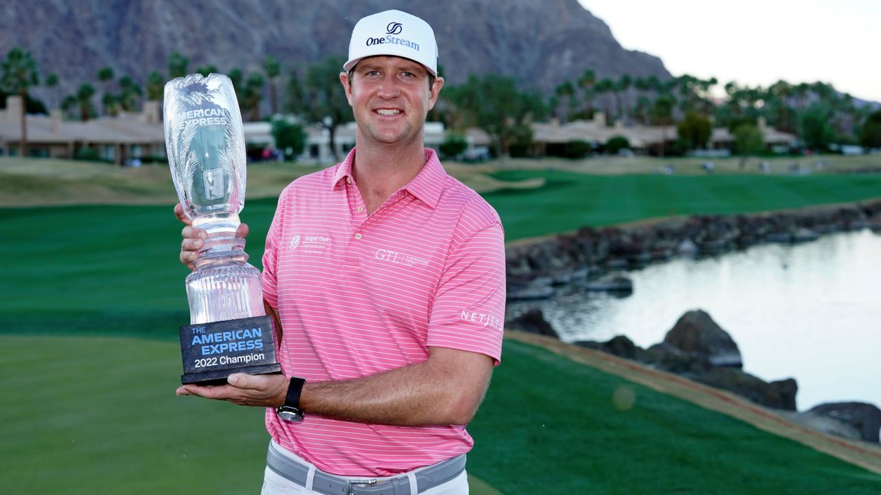 Hudson Swafford holds the winner's trophy at the end of the American Express golf tournament on the Pete Dye Stadium Course at PGA West, Sunday, Jan. 23, 2022, in La Quinta, Calif. (AP Photo/Marcio Jose Sanchez)