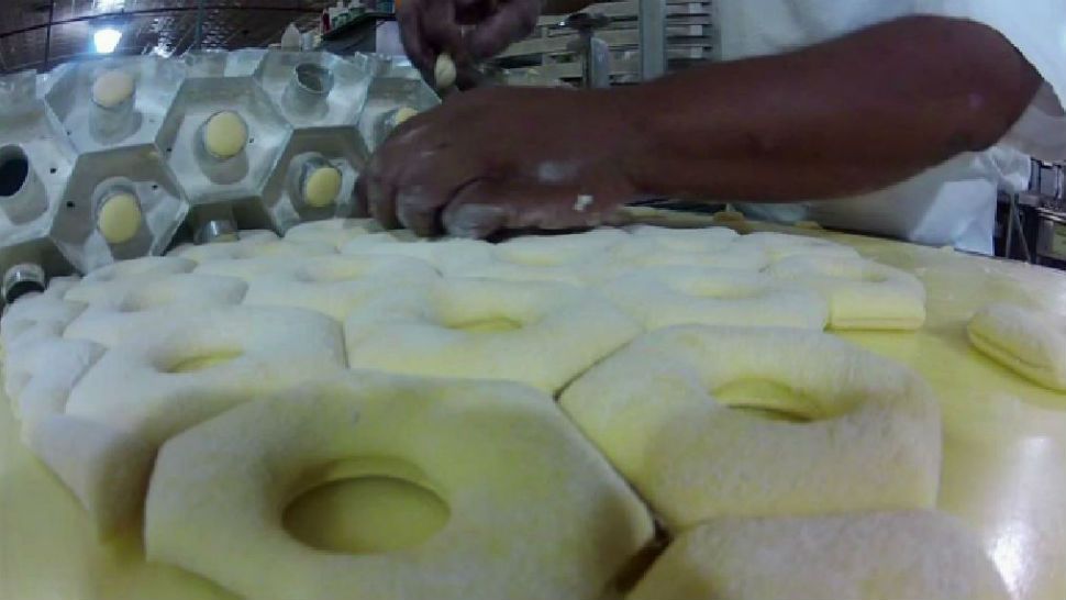 Baker making donuts for Gourdough's. (Spectrum News)