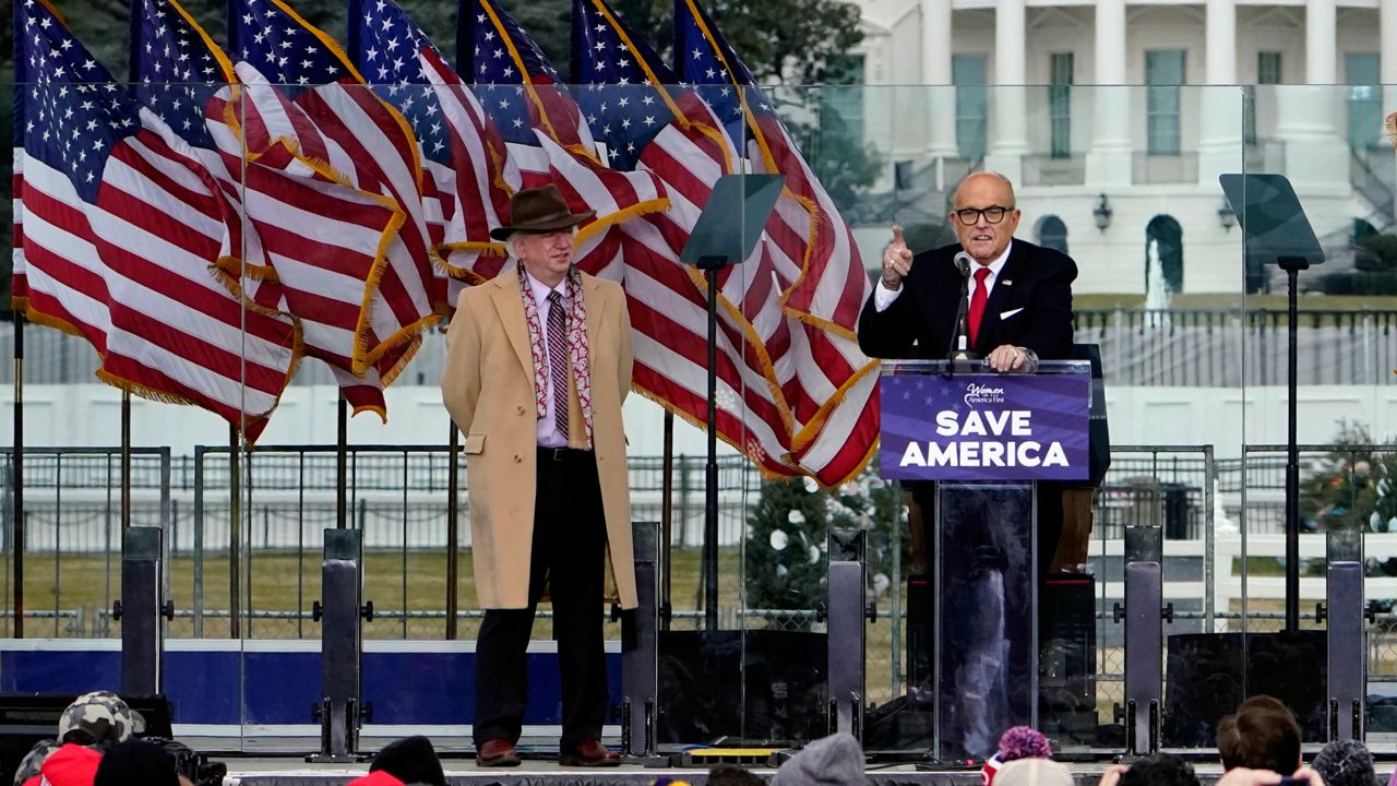 Chapman University law professor John Eastman stands at left as former New York Mayor Rudolph Giuliani speaks in Washington at a rally in support of President Donald Trump, called the "Save America Rally" on Jan. 6, 2021. (AP Photo/Jacquelyn Martin, File)