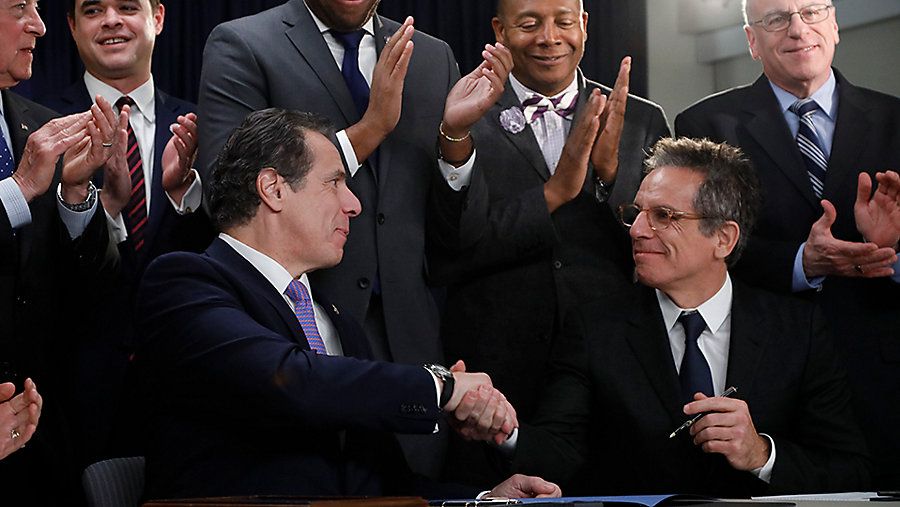New York Gov. Andrew Cuomo, left, and actor Ben Stiller shake hands.