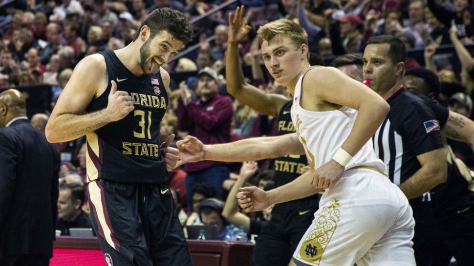 Florida State forward Wyatt Wilkes (31) reacts to his score as he runs backwards in front of Notre Dame guard Dane Goodwin (23) the second half of an NCAA college basketball game in Tallahassee, Fla., Saturday, Jan. 25, 2020. Florida State defeated Notre Dame 85-84. (AP Photo/Mark Wallheiser)
