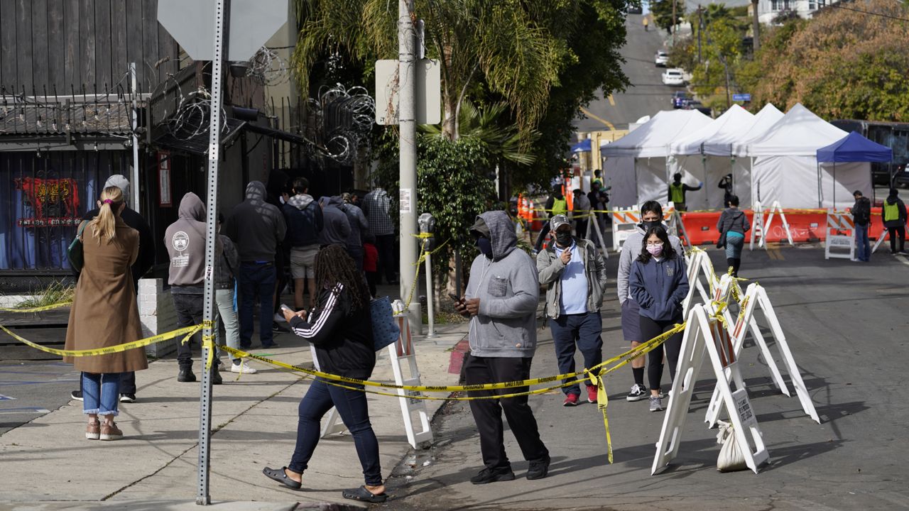 People line up for a COVID-19 test in Los Angeles Monday, Jan. 25, 2021. (AP Photo/Damian Dovarganes)