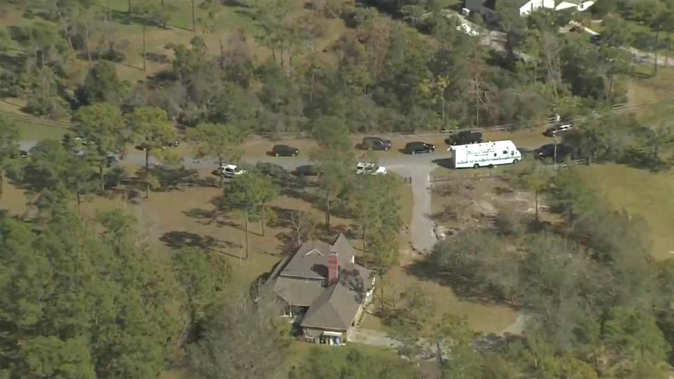 Seminole County Sheriff's officials line Sultan Circle in Chuluota, where detectives were investigating a triple homicide Friday morning. (Sky 13)