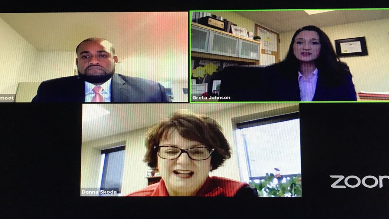 Three people speak on a computer screen