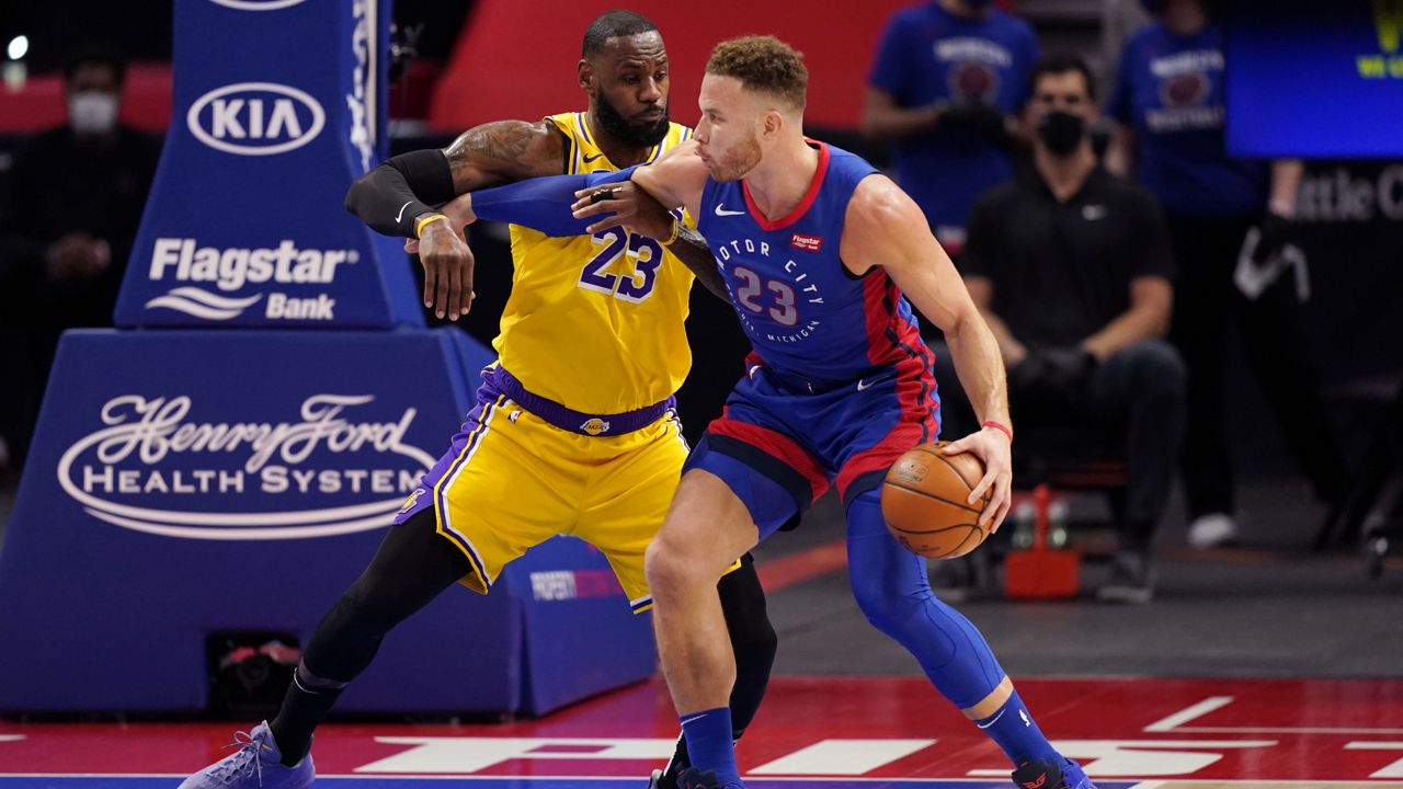 Detroit Pistons forward Blake Griffin (23) is defended by Los Angeles Lakers forward LeBron James (23) during the first half of an NBA basketball game, Thursday, Jan. 28, 2021, in Detroit. (AP Photo/Carlos Osorio)