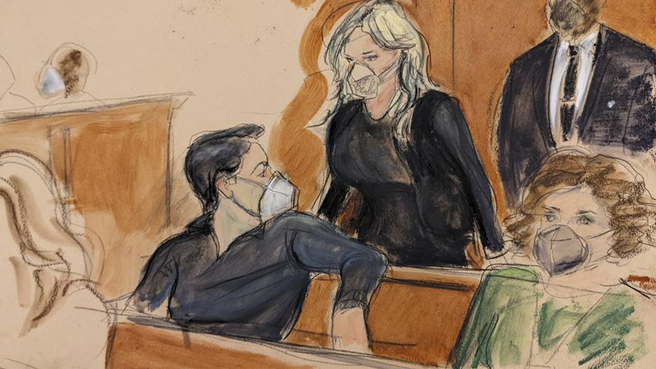 In this courtroom sketch, Michael Cohen, seated left in the back row of the courtroom, turns and looks at Stormy Daniels as she enters court to testify, in New York, Friday, Jan. 28, 2022. (AP Photo/Elizabeth Williams)