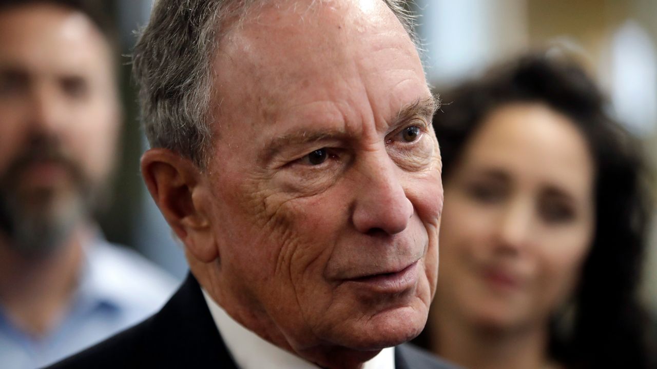 Mike Bloomberg, wearing a white dress shirt and a black suit jacket.