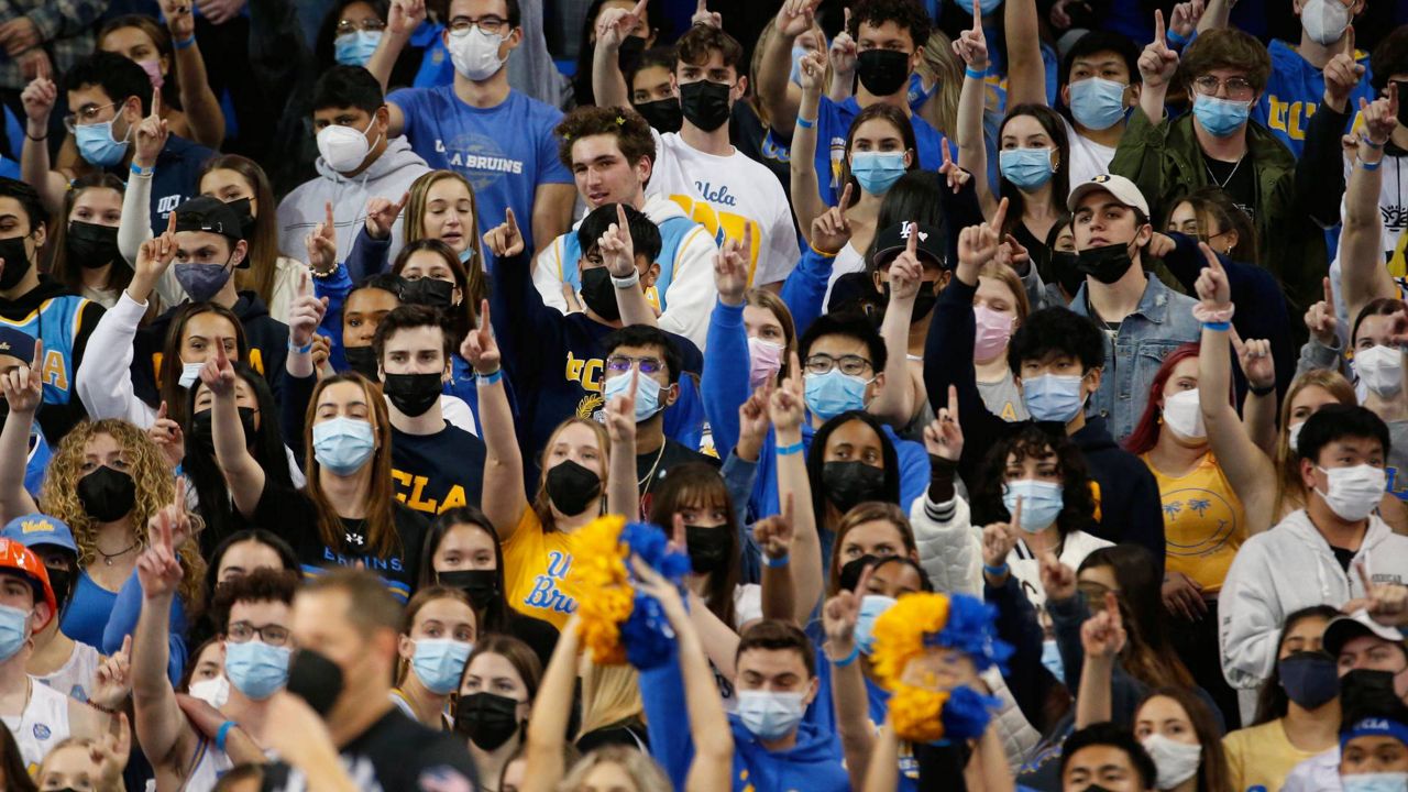 UCLA fans wearing face masks watch in the first half of an NCAA college basketball game against Stanford, Jan. 29, 2022, in Los Angeles. (AP Photo/Ringo H.W. Chiu)