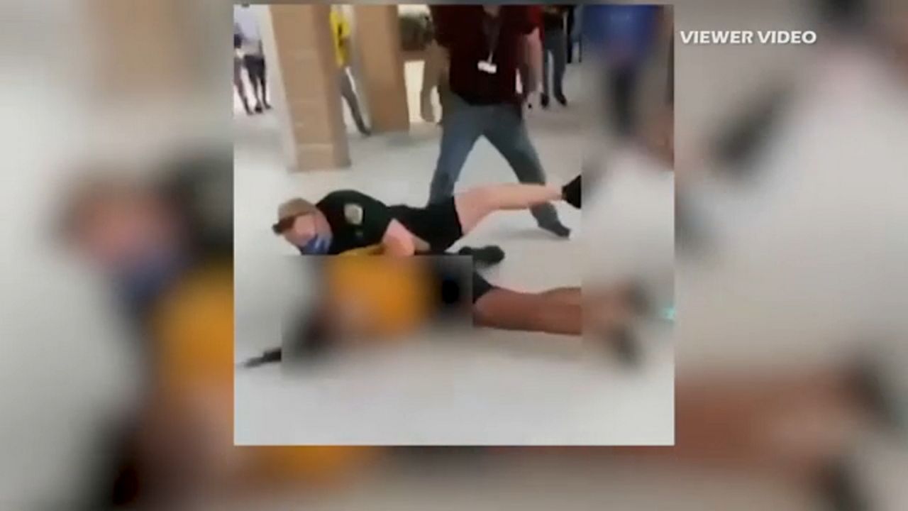 Osceola County deputy is seen taking a student to the ground during an incident at Liberty High School in January. (Screen capture from viewer video)