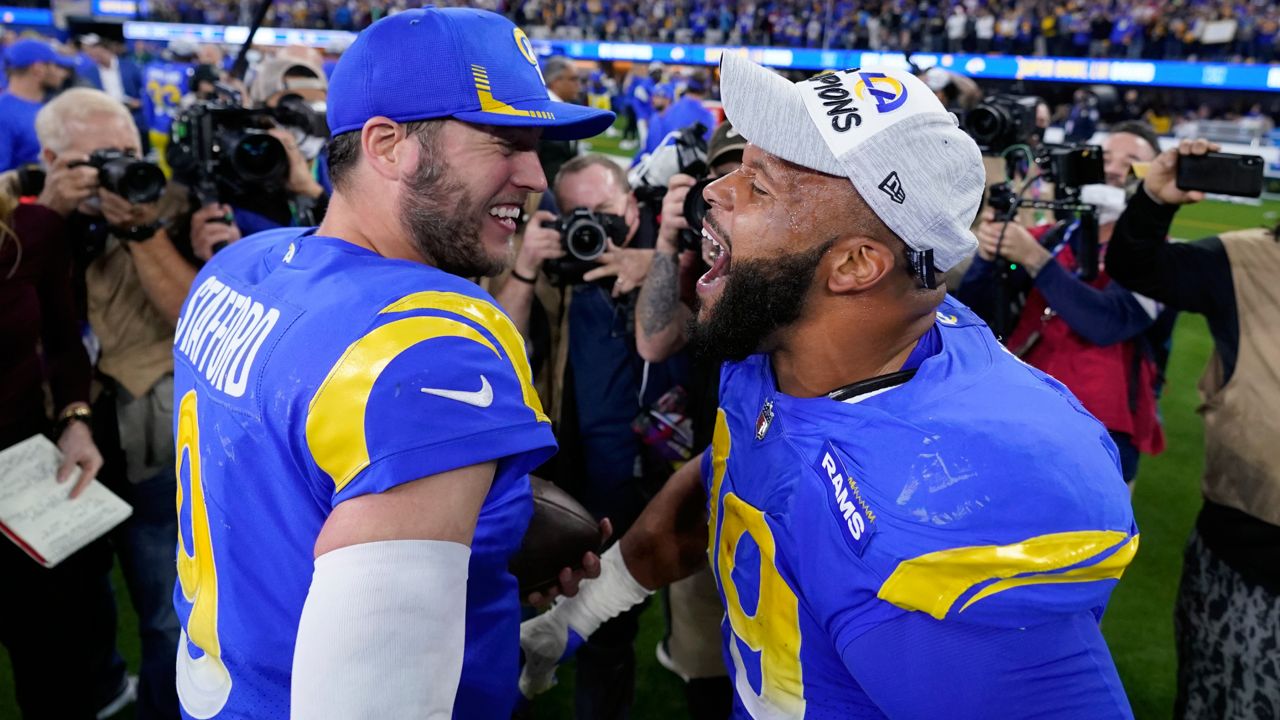 Los Angeles Rams' Matthew Stafford, left, and Aaron Donald celebrate after the NFC Championship NFL football game against the San Francisco 49ers Sunday, Jan. 30, 2022, in Inglewood, Calif. The Rams won 20-17 to advance to the Super Bowl. (AP Photo/Marcio Jose Sanchez)