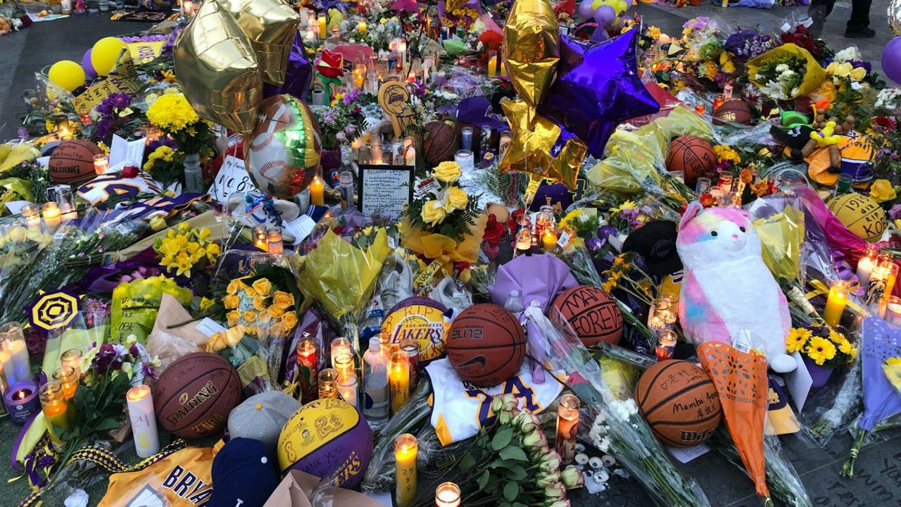 The growing memorial for Kobe Bryant outside Staples Center this morning is a sea of purple, gold, and personal messages about what the Lakers legend meant to Southern Californians and the rest of the country. (Spectrum News/ Kristen Lago)