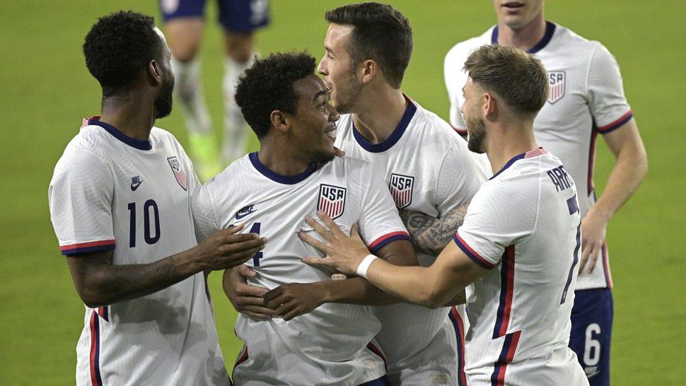 The United States forward Jonathan Lewis (14) is congratulated by teammates Kellyn Acosta (10), Aaron Herrera (2), and Paul Arriola (7) after Lewis scored a goal during the first half of an international friendly soccer match against Trinidad and Tobago, Sunday, Jan. 31, 2021, in Orlando, Fla. (AP Photo/Phelan M. Ebenhack)