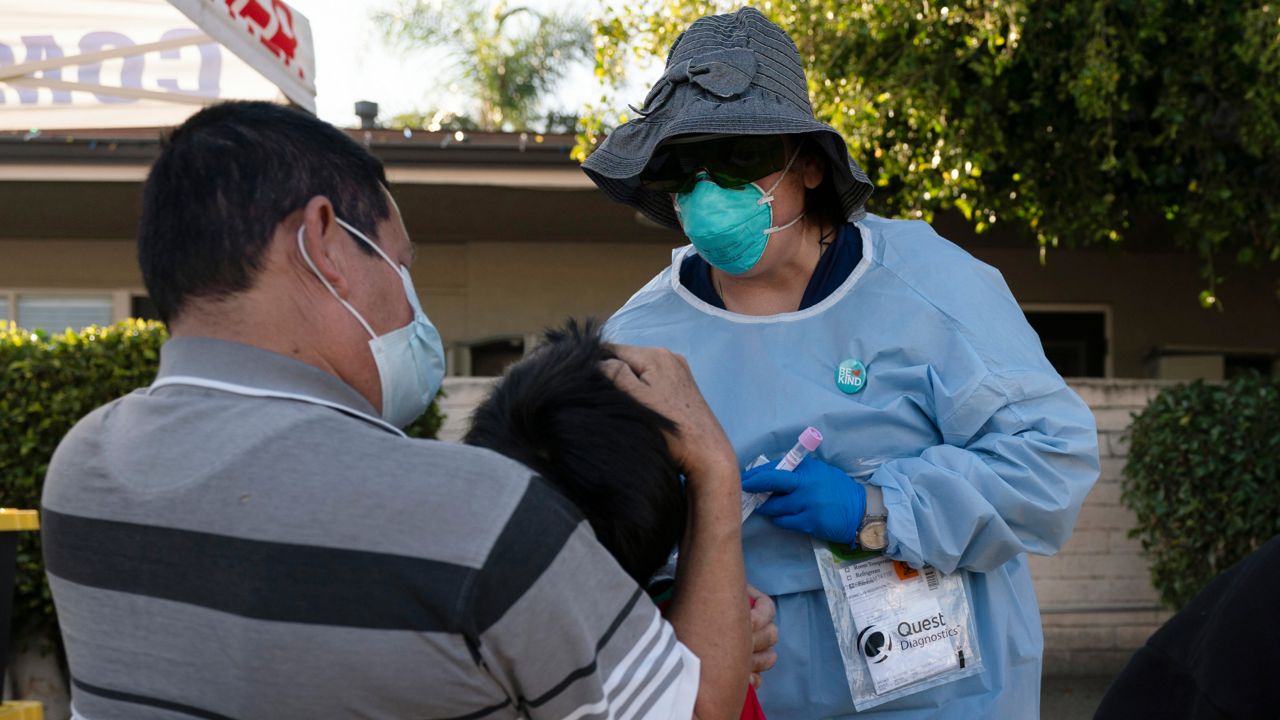 Nurse practitioner Rita Ray collects a nasal swab sample from Sebastian Hernandez, 5, for a COVID-19 test at Families Together of Orange County community health center in Tustin, Calif., Jan. 6, 2022. (AP Photo/Jae C. Hong, File)