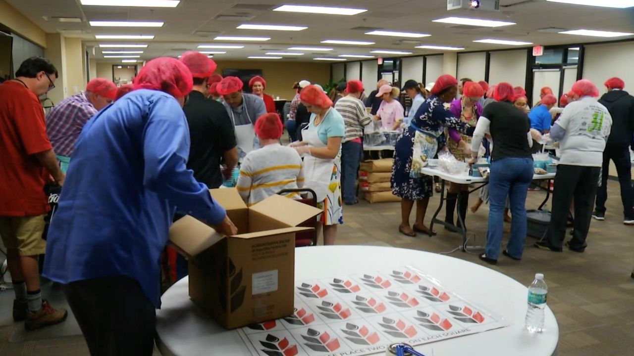 Thursday night, Rise Against Hunger joined forces with employees from HCI Group Inc. and made 11,000 meals in 90 minutes. (Gabrielle Arzola/Spectrum Bay News 9)
