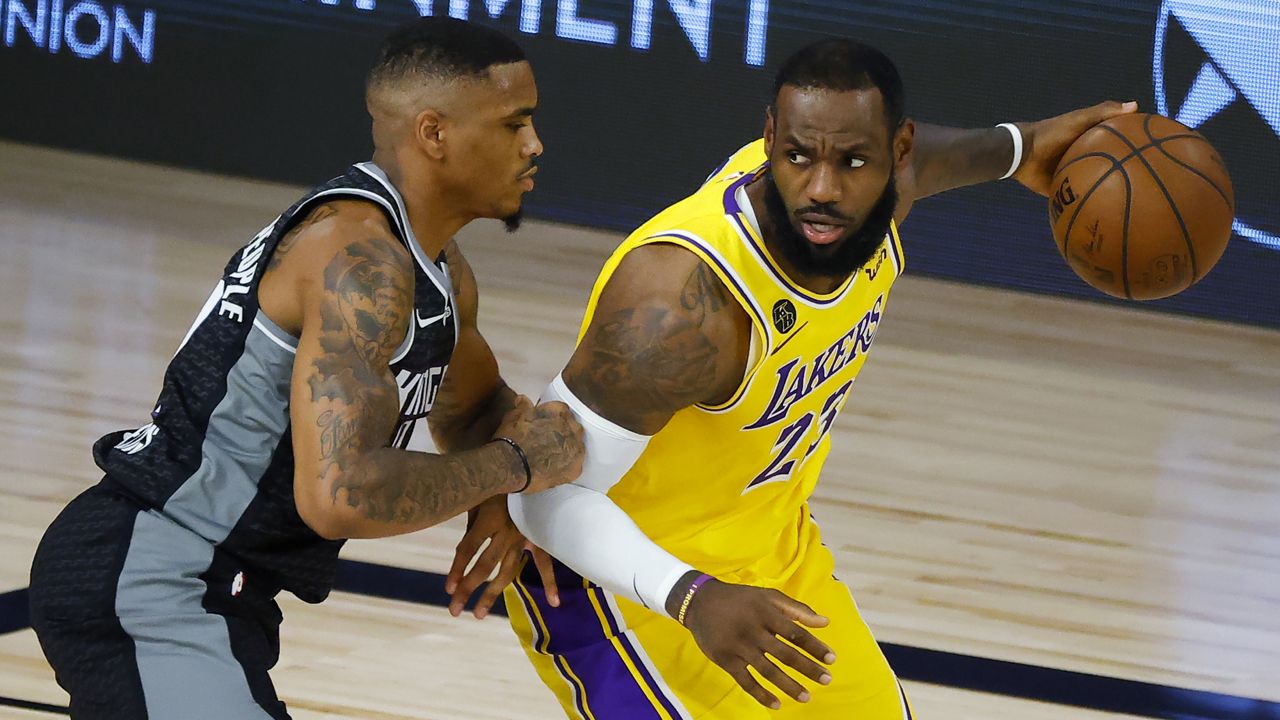 Sacramento Kings' DaQuan Jeffries, left, defends against Los Angeles Lakers' LeBron James during the  second quarter of an NBA basketball game Thursday, Aug. 13, 2020, in Lake Buena Vista, Fla. (Kevin C. Cox/Pool Photo via AP)