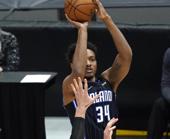 Orlando Magic center Wendell Carter Jr., top, shoots against Chicago Bulls center Nikola Vucevic during the first half of an NBA basketball game in Chicago, Wednesday, April 14, 2021. (AP Photo/Nam Y. Huh)