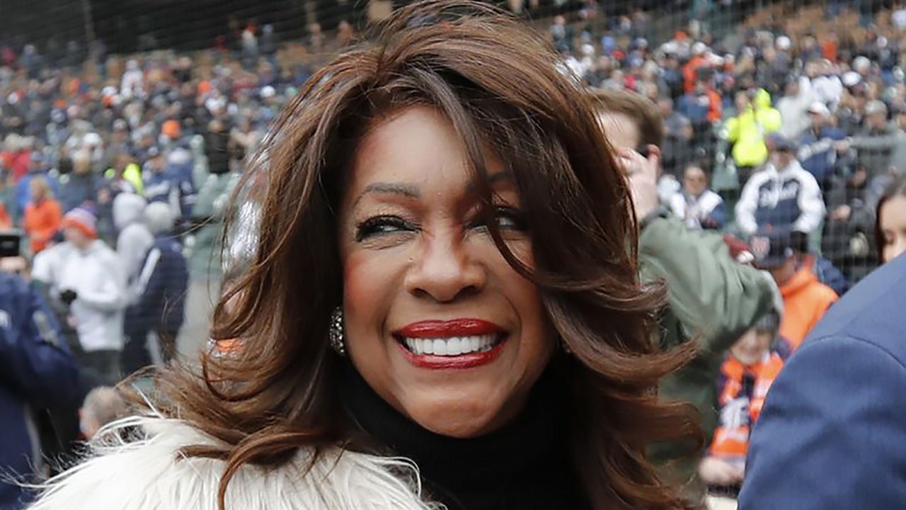 In this April 4, 2019, file photo, Mary Wilson, a former member of The Supremes, is escorted after singing the national anthem before a baseball game between the Detroit Tigers and the Kansas City Royals in Detroit. Wilson died in Las Vegas, publicist Jay Schwartz told KABC-TV. When she died and other details weren’t immediately clear. She was 76. (AP Photo/Carlos Osorio, File)