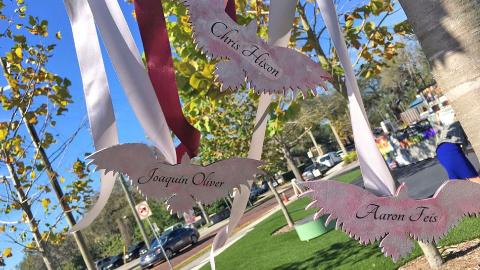 One year since the Parkland shooting and the onePulse organization is having a one-year remembrance event at 2 p.m., Thursday, February 14, 2019. Hannah is getting ready for it by hanging red and silver Eagles with the names of  Marjory Stoneman Douglas High School victims on some of the trees.(Erin Murray/Spectrum News)