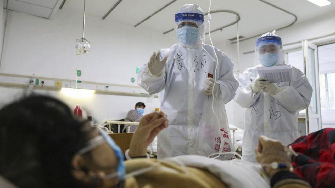 Medical workers check on the conditions of patients in Jinyintan Hospital, designated for critical COVID-19 patients, in Wuhan in central China's Hubei province Thursday, Feb. 13, 2020. China on Thursday reported 254 new deaths and a spike in virus cases of 15,152, after the hardest-hit province of Hubei applied a new classification system that broadens the scope of diagnoses for the outbreak, which has spread to more than 20 countries. (Chinatopix Via AP)