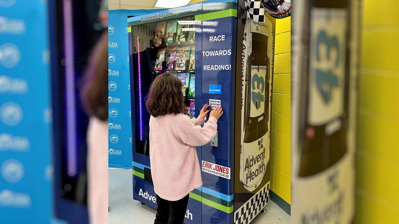 NASCAR's Erik Jones donates book vending machine to school